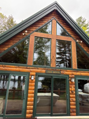 Clean A-frame log cabin windows in Maine